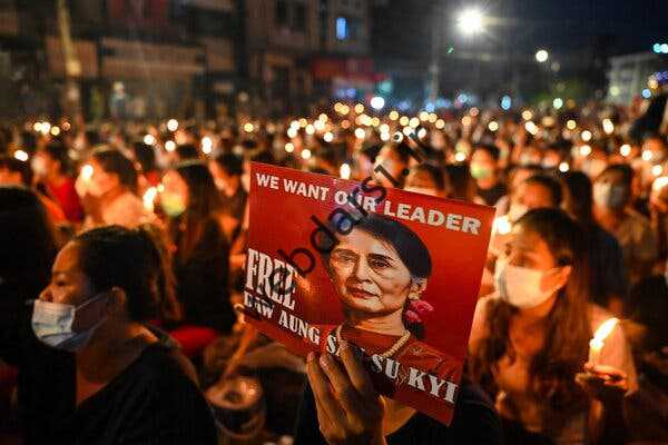 معترضان پلاکاردی با عکس‌های رهبر عمومی بازداشت شده داو آنگ سان سوچی در ماه مارس در یانگون میانمار در دست دارند.